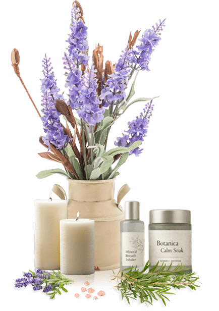 A beige vase with purple lavender, two white candles, and spa products, including a bottle and jar labeled "Botanica," against a black background.